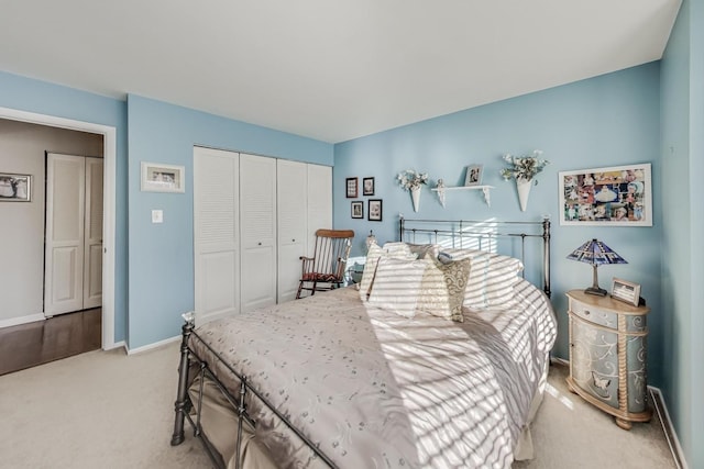 bedroom with light carpet and a closet