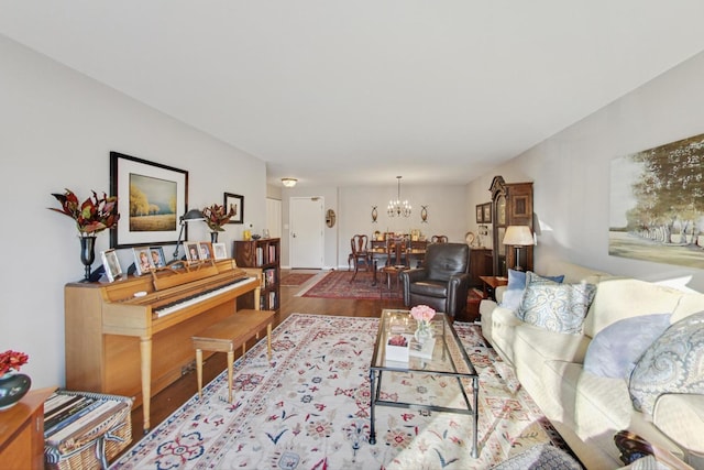 living room with hardwood / wood-style floors and a notable chandelier