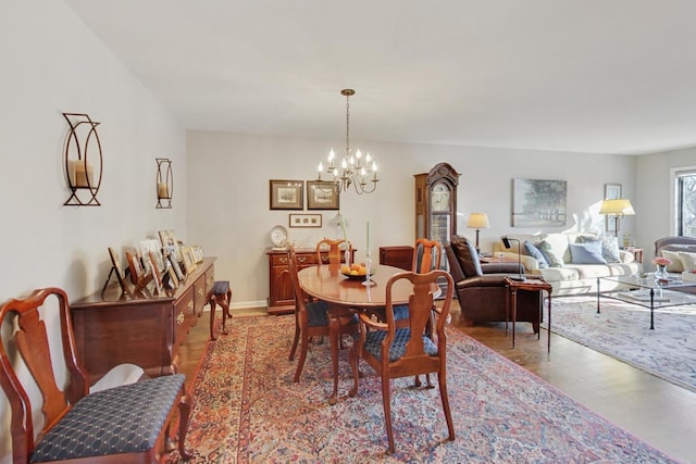 dining room featuring wood-type flooring and a chandelier