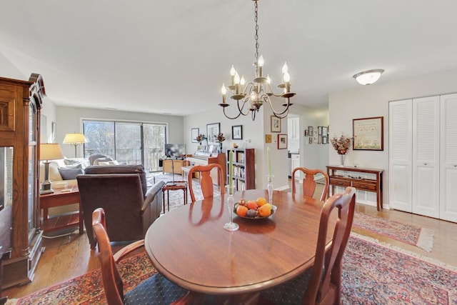 dining room with a notable chandelier and light hardwood / wood-style flooring