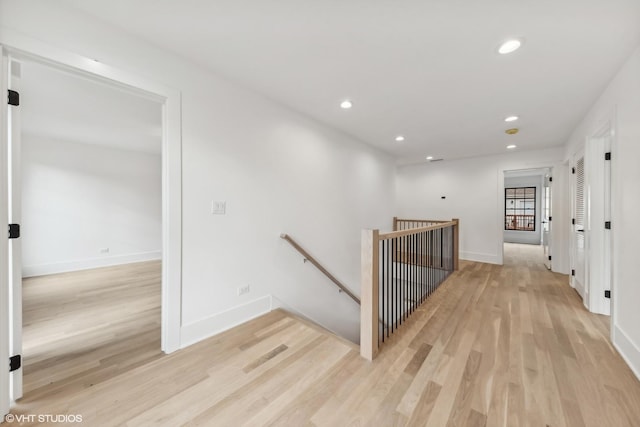 hallway with light hardwood / wood-style flooring