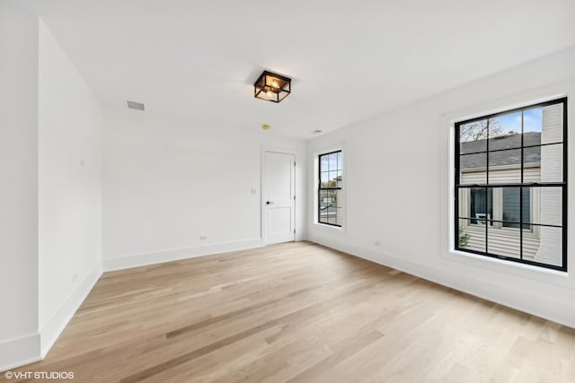 unfurnished room with light hardwood / wood-style floors