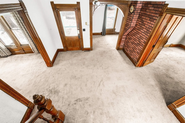 entrance foyer featuring light colored carpet