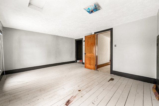 spare room with light hardwood / wood-style floors