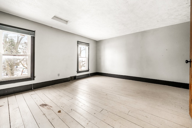 unfurnished room featuring light hardwood / wood-style floors