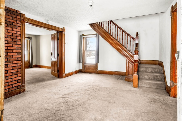 interior space with light carpet and a textured ceiling