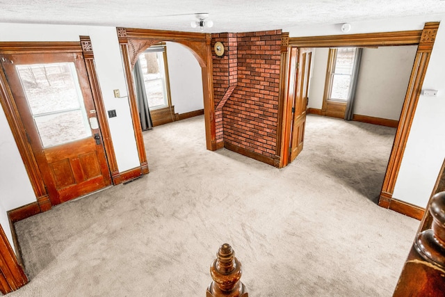 interior space featuring light carpet and a textured ceiling