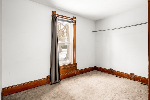 unfurnished room with light carpet