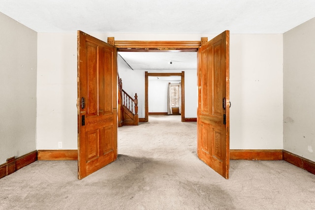 spare room featuring light colored carpet