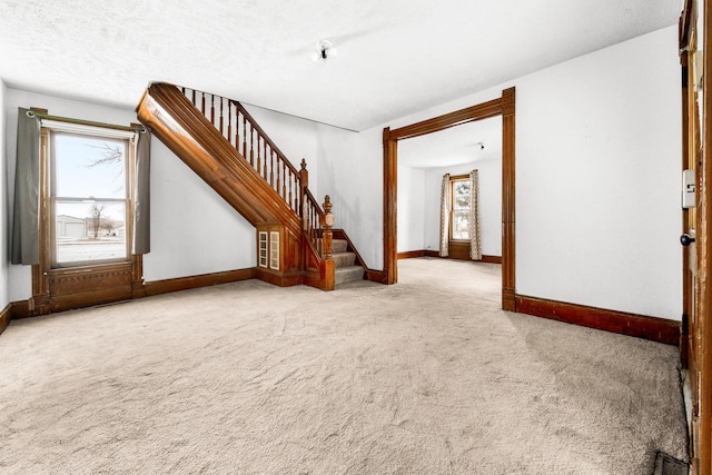 unfurnished living room featuring light colored carpet