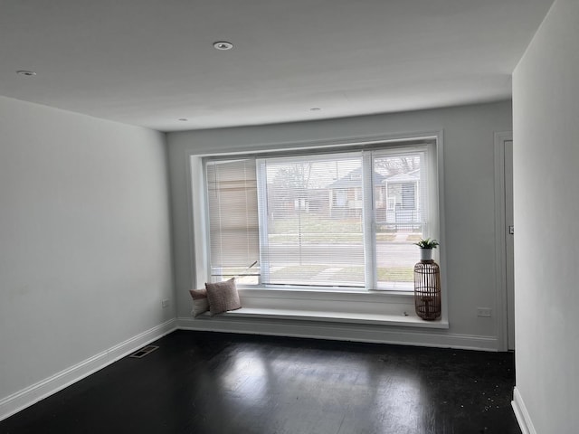 spare room with dark wood-type flooring