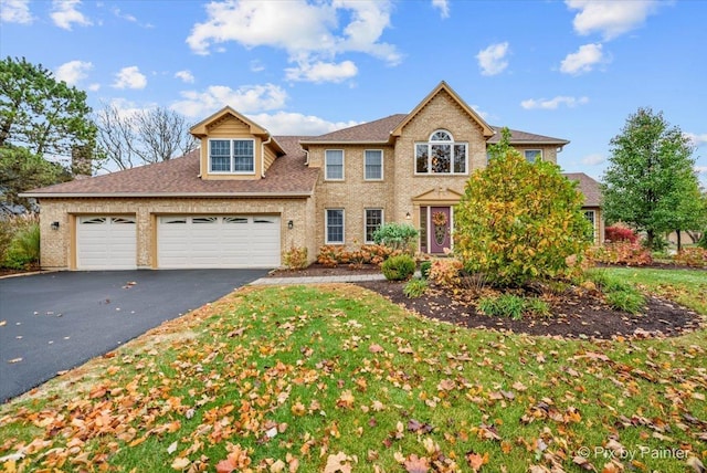 view of front of house featuring a front lawn and a garage