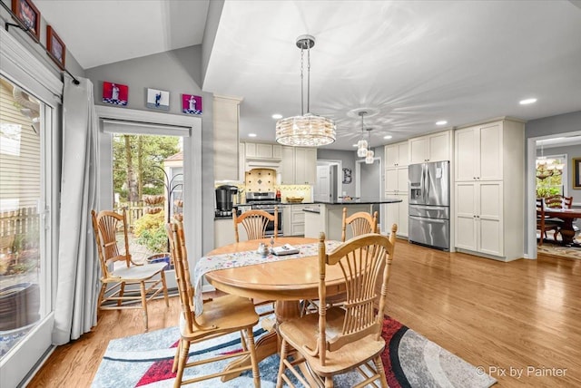 dining room featuring light hardwood / wood-style floors and a notable chandelier