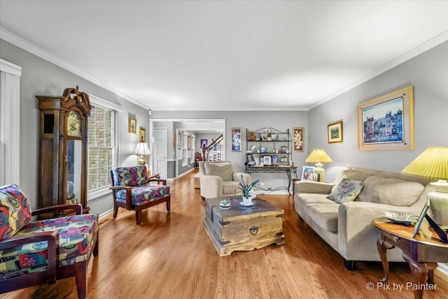 living room with wood-type flooring and ornamental molding