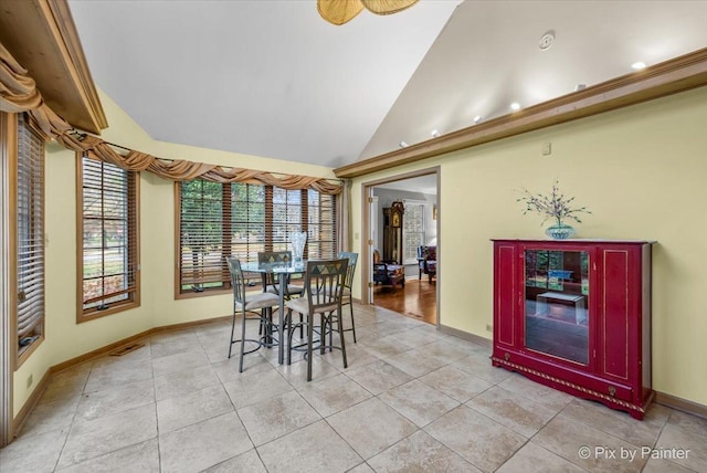 dining room featuring light tile patterned floors and lofted ceiling