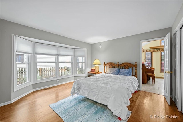 bedroom featuring light wood-type flooring and a closet