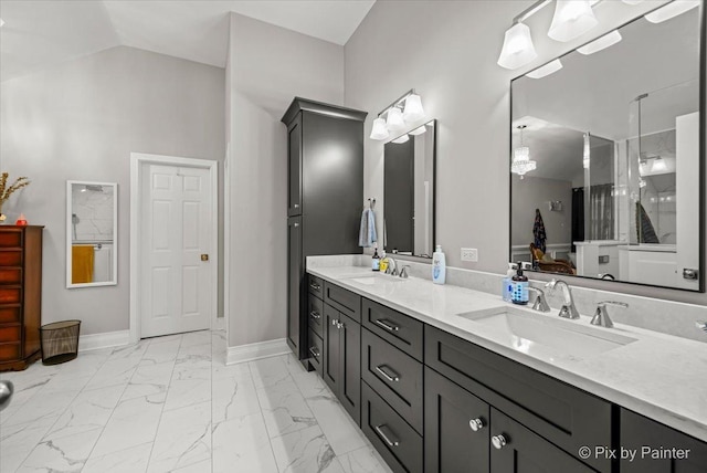 bathroom with vanity and lofted ceiling