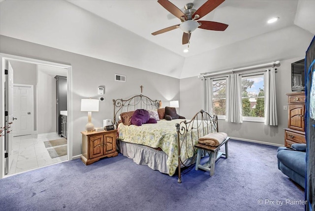 bedroom featuring ceiling fan, light colored carpet, lofted ceiling, and connected bathroom