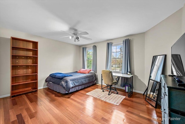 bedroom with ceiling fan and hardwood / wood-style flooring