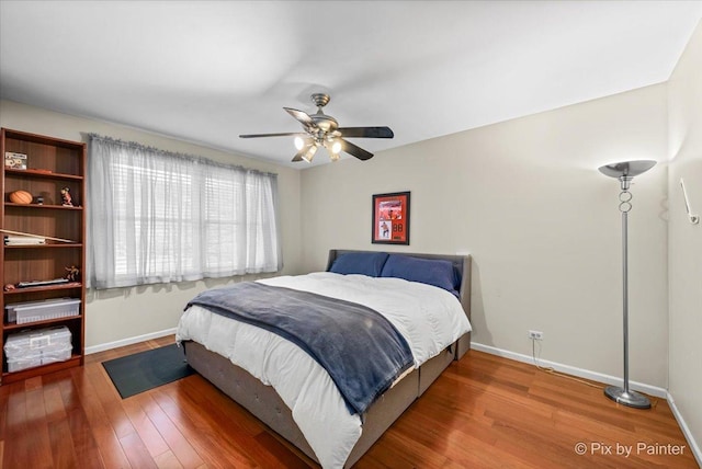 bedroom with hardwood / wood-style floors and ceiling fan