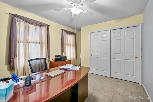 home office with carpet flooring, a wealth of natural light, and ceiling fan