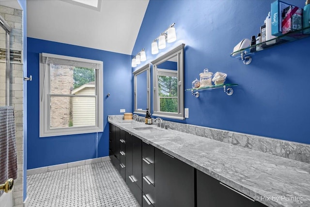 bathroom with a healthy amount of sunlight, vanity, and lofted ceiling