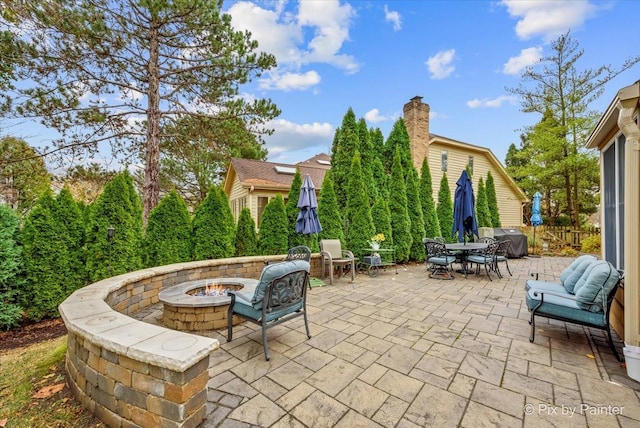 view of patio / terrace with grilling area and a fire pit