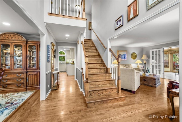 foyer entrance featuring light hardwood / wood-style floors and ornamental molding