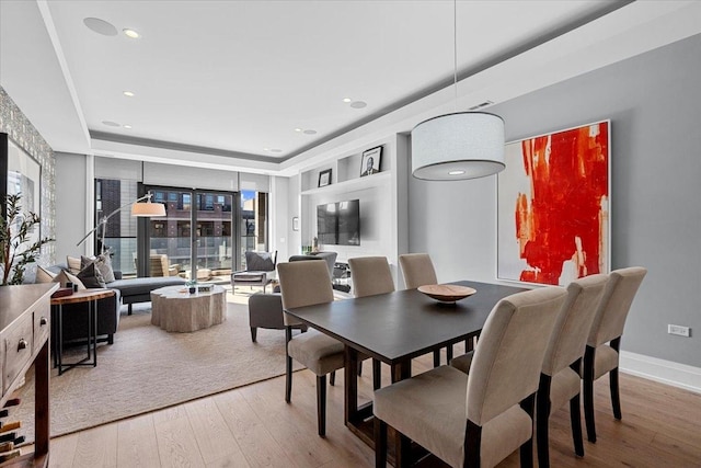 dining space featuring a healthy amount of sunlight and wood-type flooring