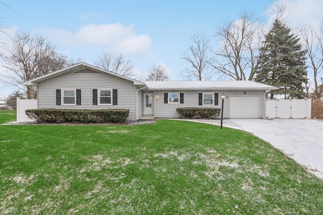 ranch-style home with a garage and a front lawn