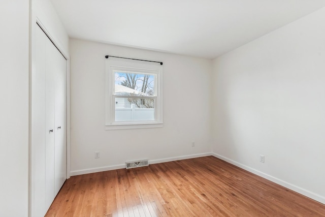 unfurnished bedroom with light hardwood / wood-style floors and a closet