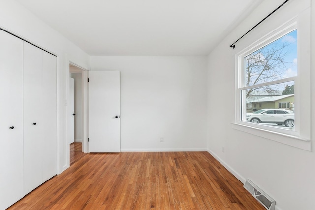 unfurnished bedroom featuring a closet and light hardwood / wood-style flooring