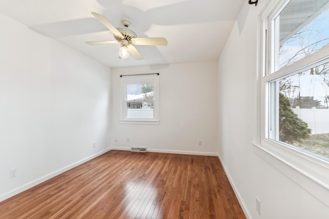 unfurnished room with hardwood / wood-style floors and ceiling fan