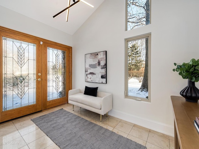 tiled foyer entrance featuring french doors, ceiling fan, and high vaulted ceiling