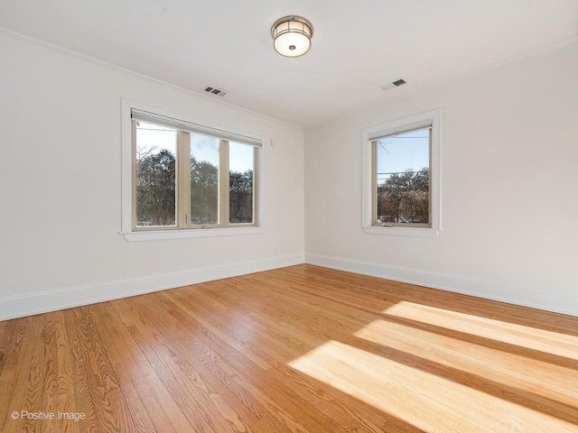 unfurnished room featuring hardwood / wood-style flooring and plenty of natural light