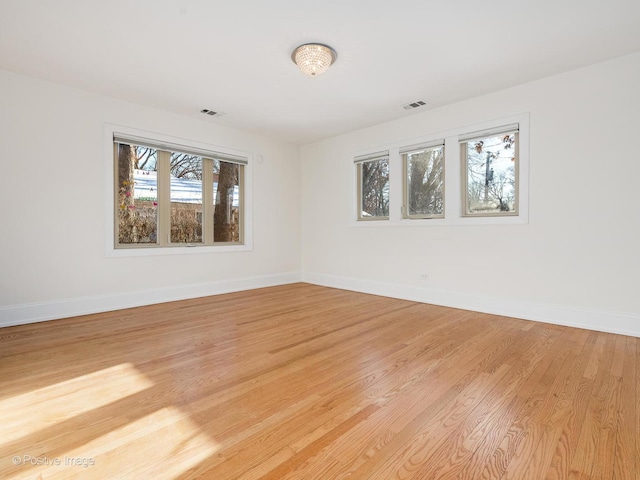 spare room featuring light hardwood / wood-style flooring