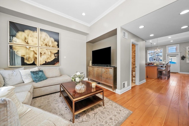 living room with ornamental molding and hardwood / wood-style floors