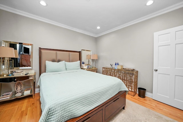 bedroom featuring light hardwood / wood-style floors and crown molding