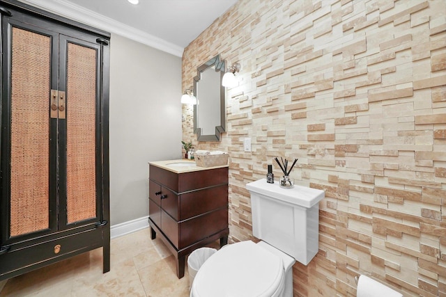 bathroom featuring toilet, vanity, and ornamental molding