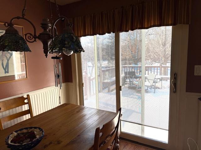 dining room with an inviting chandelier and hardwood / wood-style flooring