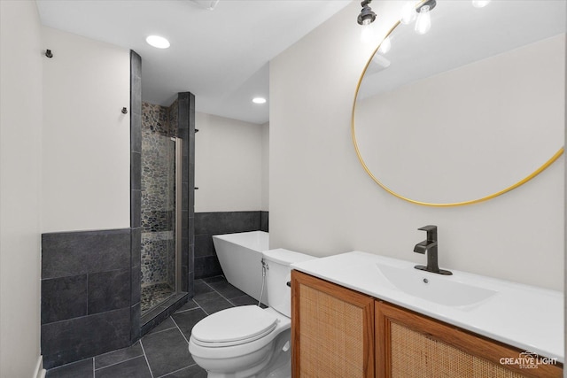 full bathroom featuring toilet, tile patterned flooring, plus walk in shower, and vanity