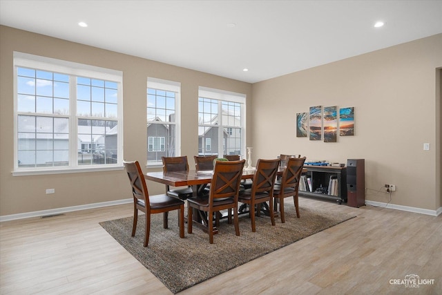 dining area featuring plenty of natural light and light hardwood / wood-style flooring