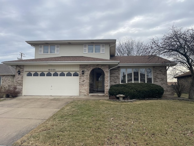 view of front of property featuring a garage and a front yard