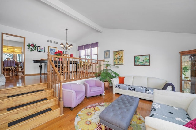 living room with an inviting chandelier, hardwood / wood-style floors, and lofted ceiling with beams