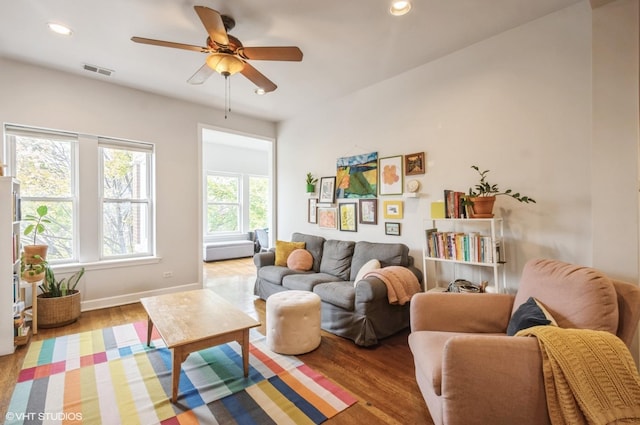 living area featuring ceiling fan and light hardwood / wood-style floors