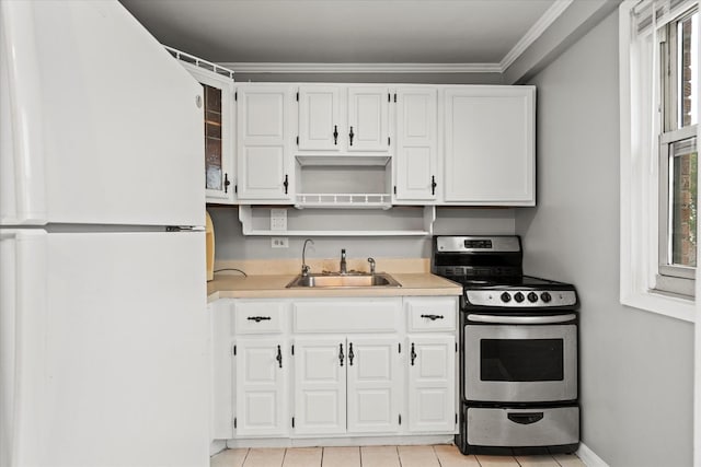 kitchen featuring white fridge, ornamental molding, stainless steel range with electric stovetop, sink, and white cabinetry