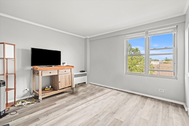 unfurnished living room with ornamental molding, radiator, and light hardwood / wood-style flooring