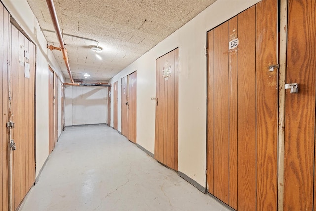 hall with a textured ceiling