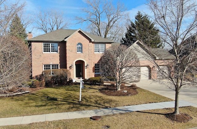 view of front facade featuring an attached garage, brick siding, concrete driveway, a chimney, and a front yard