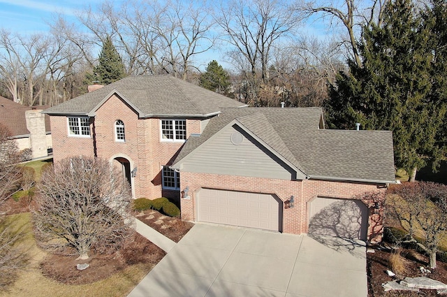 view of front of house with a garage, a shingled roof, concrete driveway, and brick siding